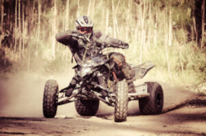 ATV racing through dirt trail: RedLawList Accidents & Injuries Blog